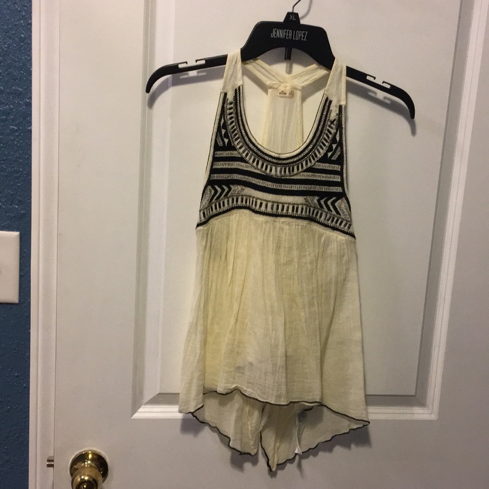 Cream tank top with black embellishment on front